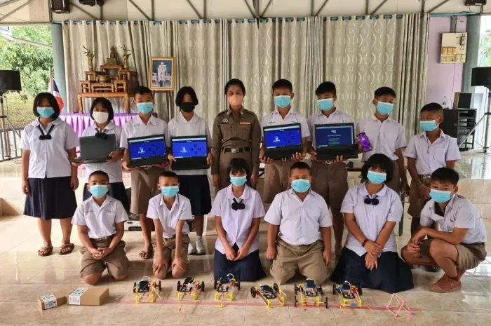 Students at a border school in Thailand with the robot cars they built