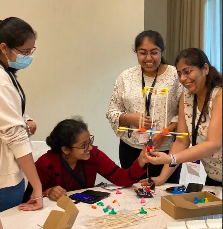 Teachers in India testing a build at a workshop table