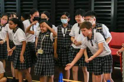 Girls cheering on their robot