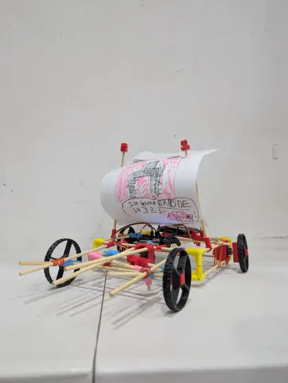 A cart with a scroll of drawings
