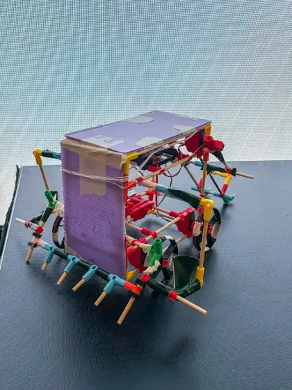 A red-framed robot with a purple box body