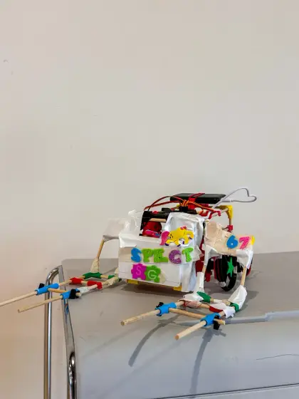A white robot covered in hand-drawn stickers