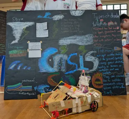 Crisis-bot in front of a chalk mural