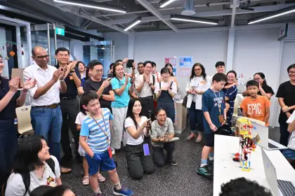 Families cheer a robot home at the VIVITA Punggol launch