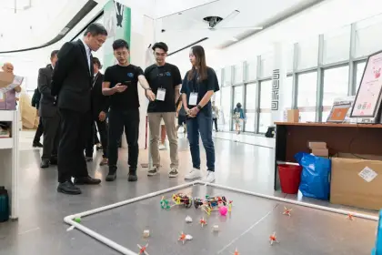 Minister Chan Chun Sing watches the cars