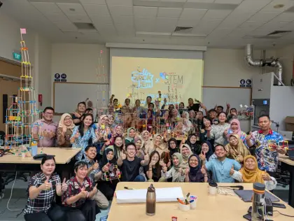 Indonesian teachers cheer beside their tower at NIE