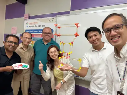 Teachers holding up a tower