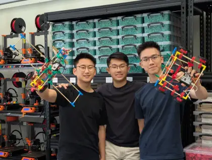 The founders in front of the printer wall