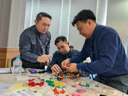 Three teachers building a car